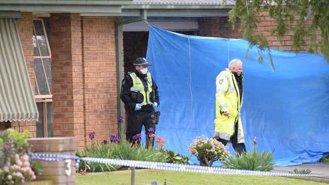 Police put up a tarp to establish the crime scene. Picture: Lawrence Pinder