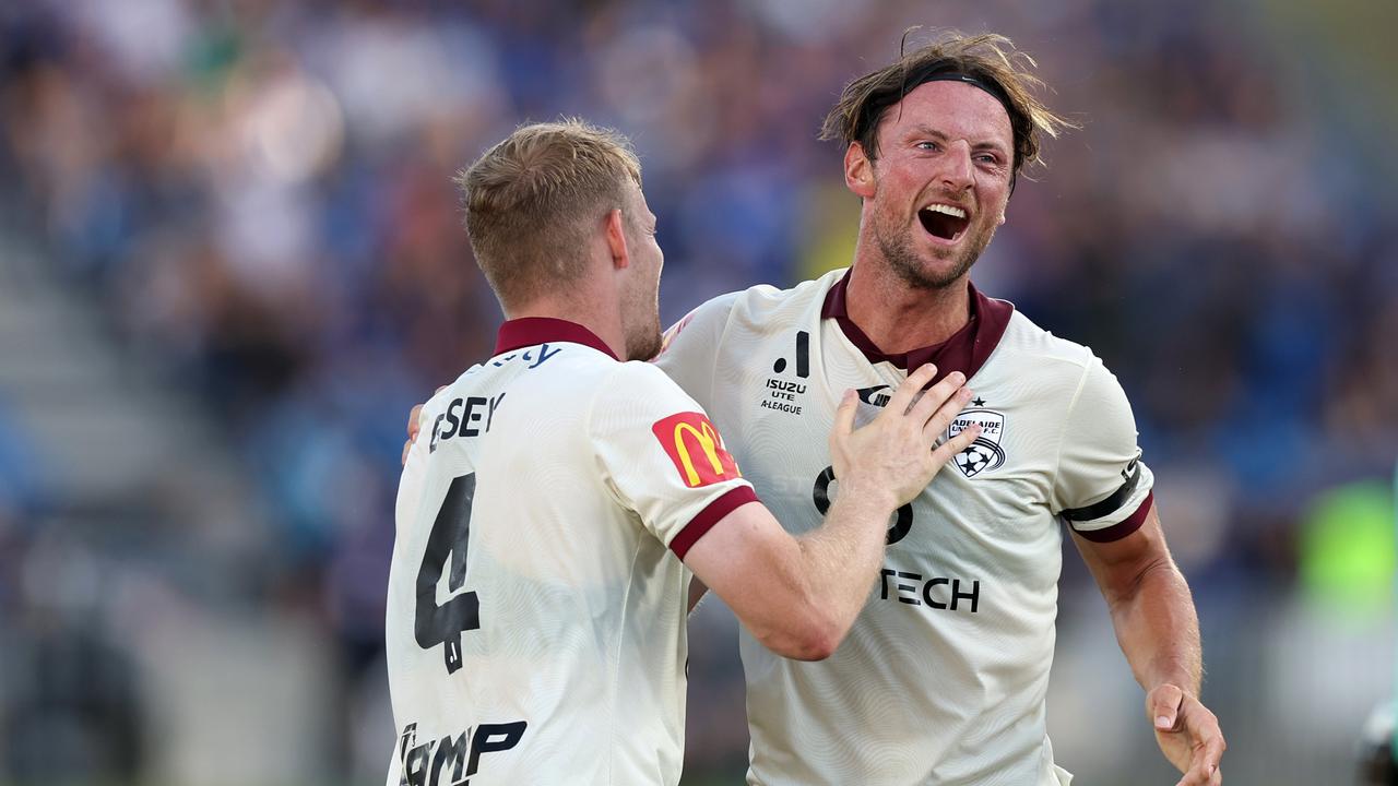 Adelaide United’s Jordan Elsey (left) and Bart Vriends celebrate a goal against Auckland FC. Picture: Fiona Goodall/Getty Images