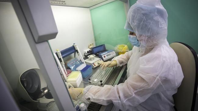 A medical staffer works with test systems for the diagnosis of coronavirus, at the Krasnodar Center for Hygiene and Epidemiology microbiology lab in Krasnodar, Russia. Russia has closed its land border with China and suspended most train traffic between the countries.