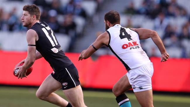 Paddy Ryder gives chase to Carlton's Sam Rowe. He has stopped limping after games following his ankle injury. Picture: Michael Klein