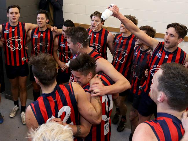 East Malvern players sing their unusual club song after defeating Highett on Saturday.