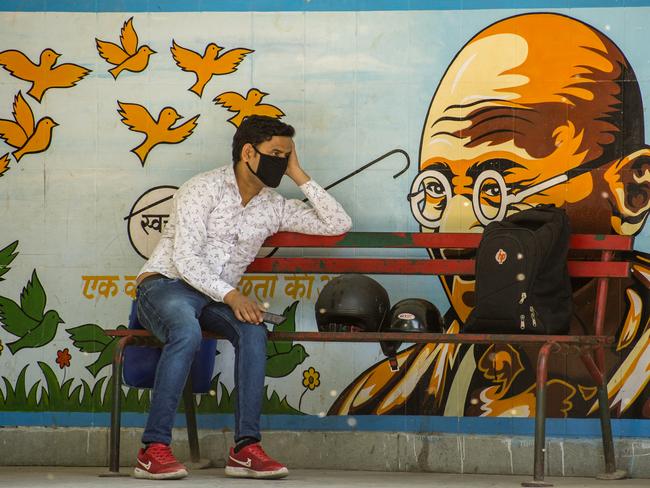 An Indian man wearing a protective mask sits on a bench, as India remains under an unprecedented lockdown over the highly contagious coronavirus in New Delhi, India. Picture: Getty