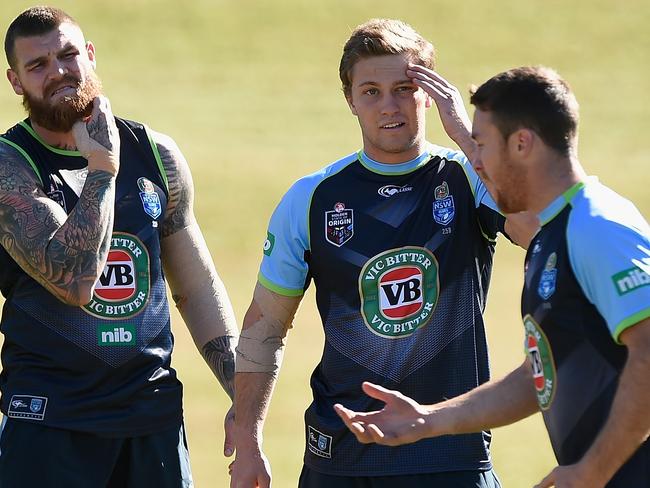 James Maloney speaks with team mates Matt Moylan, Josh Dugan during a Blues training session.