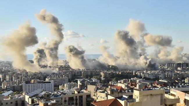 Smoke billows above Beirut’s southern suburbs following an Israeli air strike, hours before a ceasefire announcement. Picture: AFP