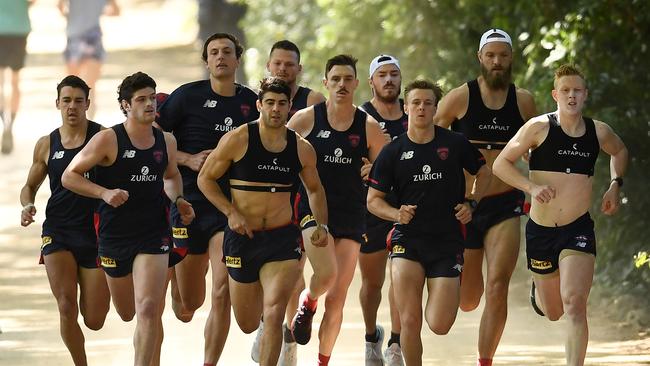 Christian Petracca, fourth from the left, leads a pack of Melbourne players during a 3km time trial in November. Picture: Quinn Rooney/Getty