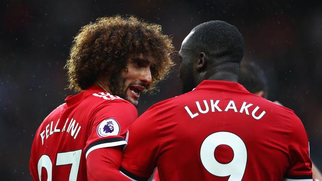 Romelu Lukaku (R) of Manchester United celebrates scoring his side's fourth goal with his team mate Marouane Fellaini (L).