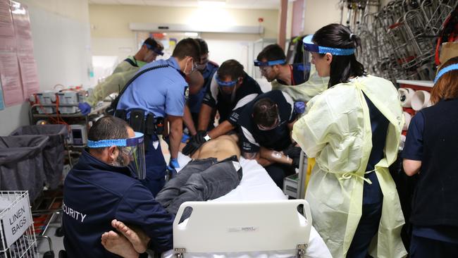 Gary Ramage’s Nikon-Walkley Photo of the Year 2015 captures a scene at the Royal Perth Hospital emergency department. A young man is brought in a state of psychosis and is treated by the emergency medical staff. Picture: Gary Ramage