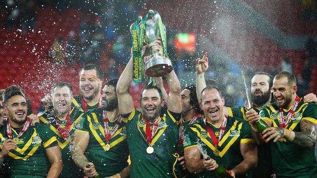 Cameron Smith lifts the trophy with teammates after victory in the Four Nations Final.