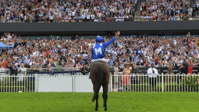 Jockey Hugh Bowman salutes the crowd after yet another Winx victory.