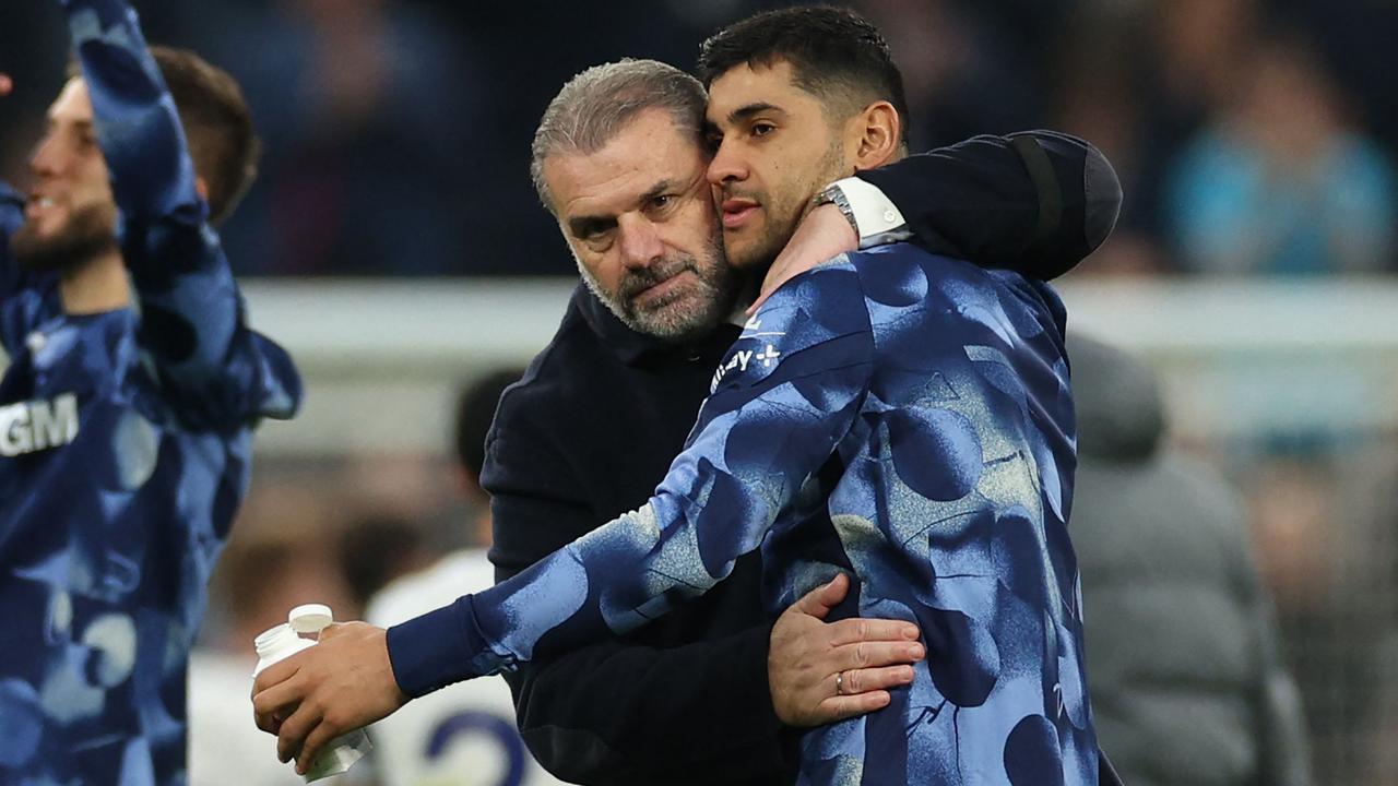 Ange Postecoglou celebrates with Tottenham Hotspur's Argentinian defender Cristian Romero. (Photo by Adrian Dennis / AFP)