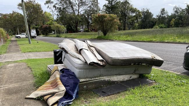 Water damaged mattresses from the July floods remained piled on the street in Rickard Rd, Moorebank, in October as residents brace themselves for another potential flood.