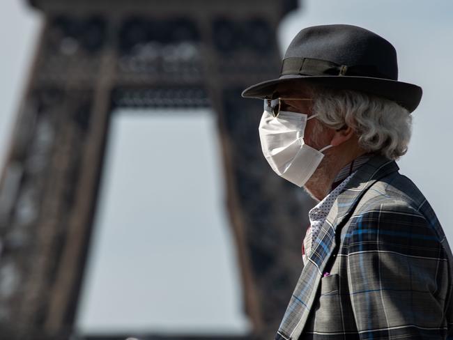 A man wearing a face mask walks near the Eiffel Tower in Paris. Picture: AFP