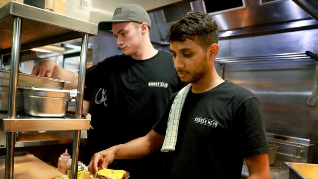 PENRITH PRESS/AAP. Burger chefs Ryley Millar and Bishal Wagle make the Better Mac burger at Burger Head. Picture: AAP Image/Angelo Velardo.