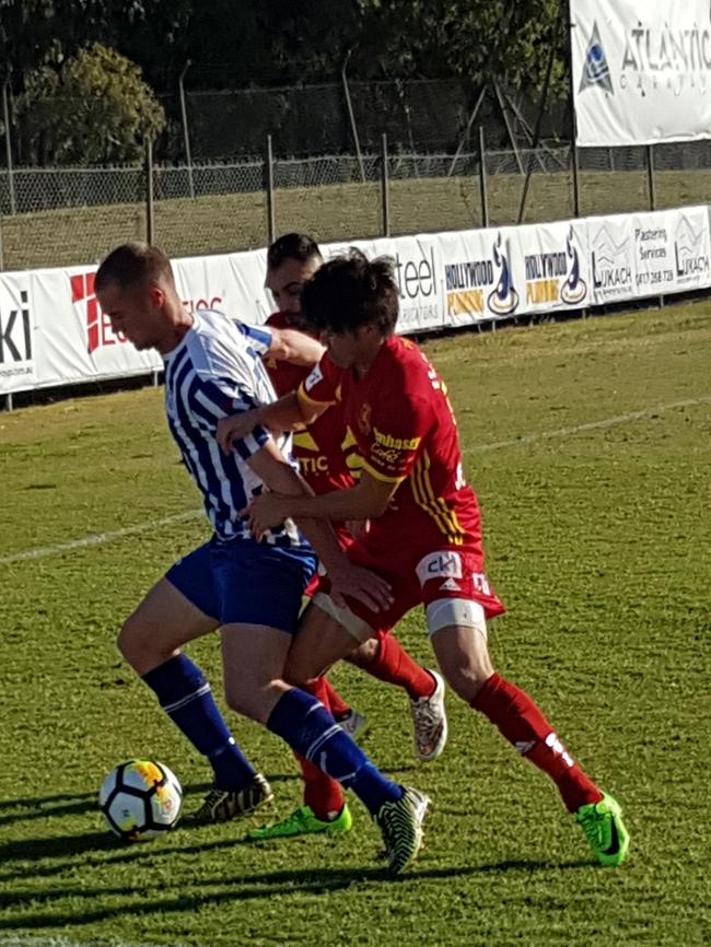 Two Preston players fight for possession with a Yarraville opponent during their State League 1 North-West fixture. Picture: Tim Michell.