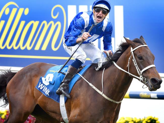 Hugh Bowman celebrates as Winx crosses the finish line on Saturday. Picture: Nicole Garmston