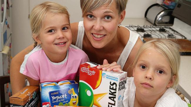 News .Story on Packaged supermarket foods are unhealthy. Rachel McIntosh and kids Zara aged 6 and Vivienne aged 4 with a whole pile of packaged foods - cereal, yoghurt, biscuits, pasta etc. The idea is that it's not a whole lot of crappy food, but the sort of food people think is going to be healthy but in fact isn't..Picture :Andrew Tauber