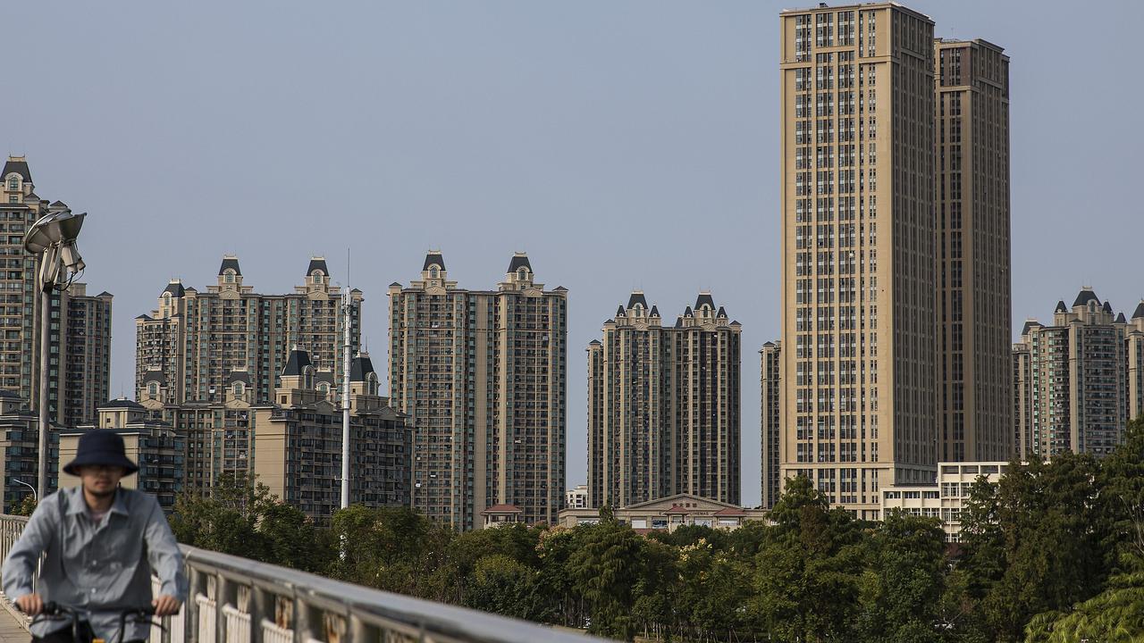 A resident cycles through the Evergrande city in Wuhan, China. Evergrande is facing a liquidity with debts of almost $300 billion. Picture: Getty Images.