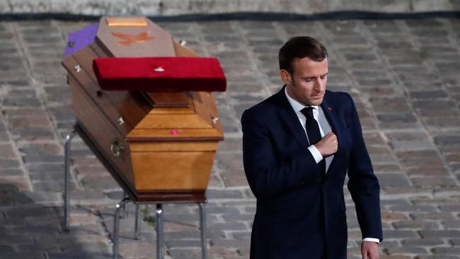 Emmanuel Macron pays his respects at the coffin of Samuel Paty inside the Sorbonne courtyard in October 2020.