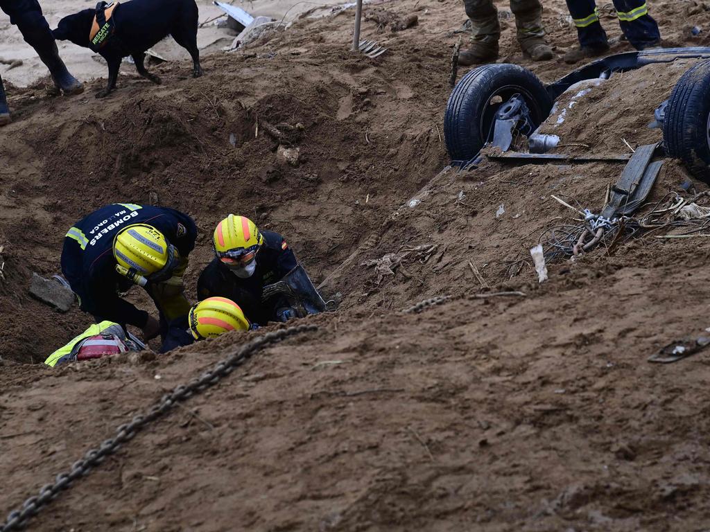 Firefighters dig up the wreckage of a car on a riverbank in Paiporta, in the region of Valencia, eastern Spain, on November 3, 2024. Picture: Jose Jordan / AFP