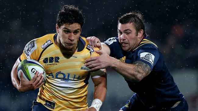 Matt Toomua of the Brumbies in the tackle of Liam Squire of the Highlanders.