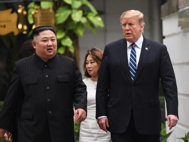 US President Donald Trump walks with North Korea's leader Kim Jong-un during a break in talks at the second US-North Korea summit at the Sofitel Legend Metropole hotel.