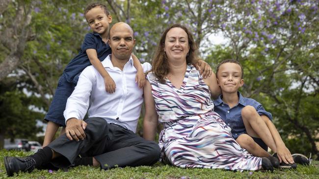 Soon to be Australian citizens Thuthuka Manasa, his wife Harriet Swatman and their two sons Matobo and Magnus enjoy the shade of jacaranda trees at St Lucia in Brisbane. Photo: Glenn Hunt