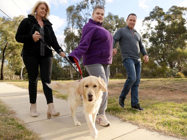 Canberra Raiders coach Ricky Stuart with his wife Kaylie and daughter Emma Stuart and her companion dog Cosmo. (AAPImage/Tracey Nearmy)