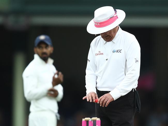 Umpire Ian Gould takes a light reading.