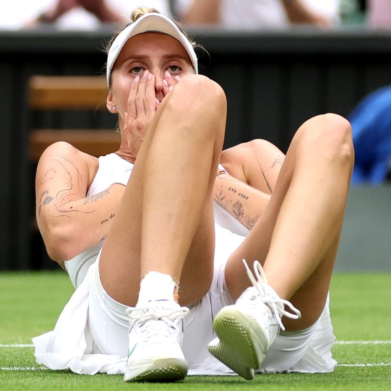 Marketa Vondrousova of Czech Republic falls to the floor as she celebrates winning match point. (Photo by Clive Brunskill/Getty Images)