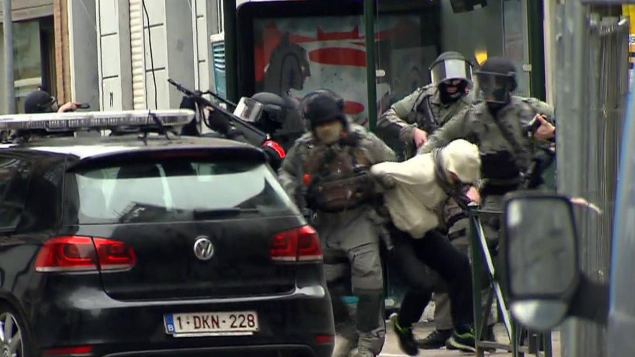 UPLOADED IMAGE - In this framegrab taken from VTM, armed police officers escort a suspect to a police vehicle during a raid in the Molenbeek neighborhood of Brussels, Belgium, Friday March 18, 2016. After an intense four-month manhunt across Europe and beyond, police on Friday captured Salah Abdeslam, the top fugitive in the Paris attacks in the same Brussels neighborhood where he grew up. (VTM via AP) BELGIUM OUT