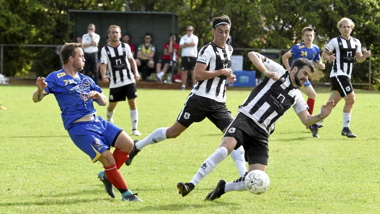 CUP CLASH: USQ's Ashley Freier (left) competes for the ball with Willowburn's Matthew Meiklejohn and Adam Daly (right). USQ won the FFA Cup game 2-0. Picture: Bev Lacey