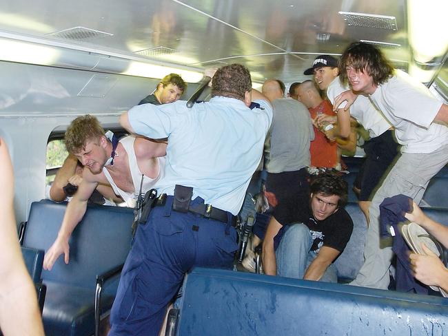 Police try to clear Aussie youths from the train. Picture: Craig Greenhill