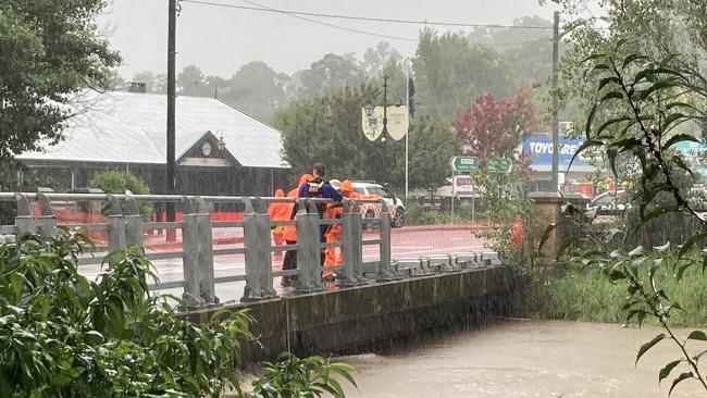 Wingecarribee SES Unit works with the Picton crew to flatten the sides of the Picton bridge, which will allow the water to flow over the bridge without flooding the main street. Picture: Adelaide Lang