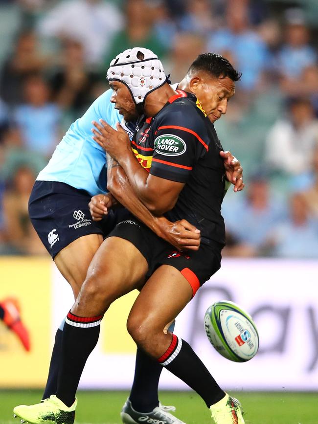 Israel Folau of the Waratahs tackles Nizaam Carr of the Stormers.