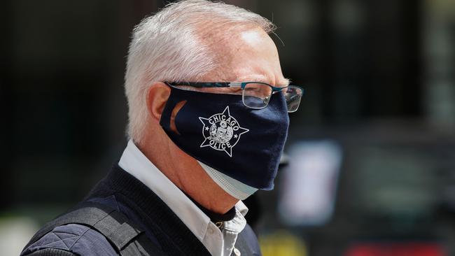 A Chicago Police officer monitors a "Ride to Recovery" car caravan protest against the coronavirus shutdown.