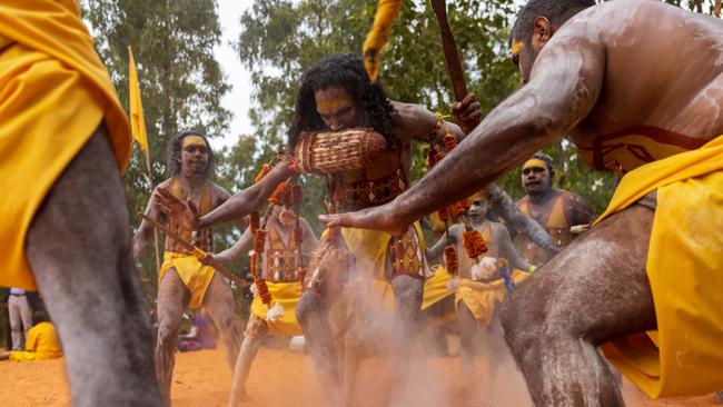 Cedric Yunupingu stamps out fire at ceremonial opening during the Garma Festival 2022. Picture: Tamati Smith/ Getty Images