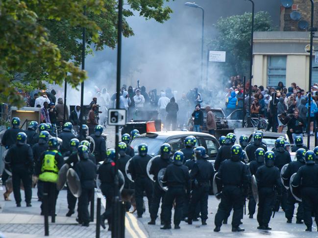 UPLOADED IMAGE -  Riot police face a mob in Hackney, north London on August 8, 2011. Riot police faced off with youths in fresh violence in London today in the third day of disorder after some of the worst rioting in the British capital in years at the weekend. The riots broke out in the north London district of Tottenham on August 6, following a protest against the death of a local man in a police shooting last week, and the violence spread to other parts of the city on August 7.  AFP PHOTO/KI PRICE