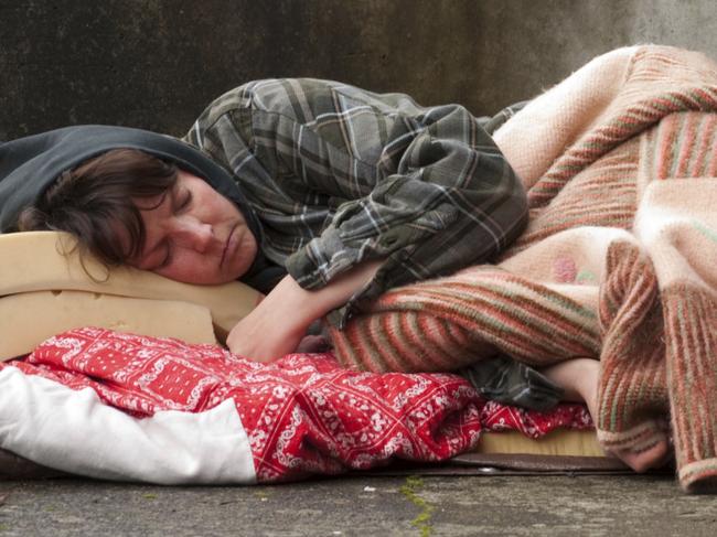 Homeless woman lying on the street.