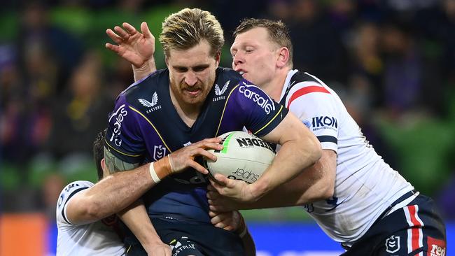 Melbourne Storm’s Cameron Munster takes on Sydney Roosters players. Picture: Quinn Rooney/Getty Images