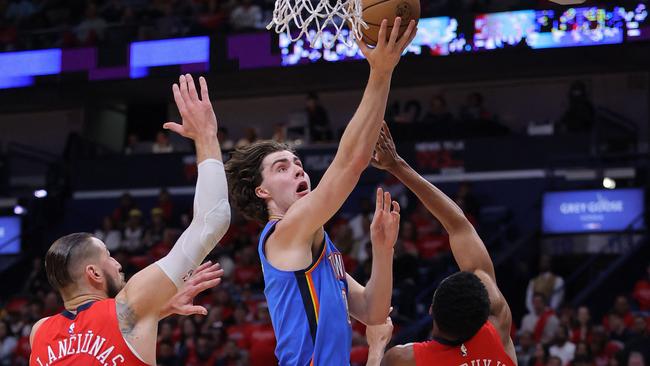 NEW ORLEANS, LOUISIANA - APRIL 12: Josh Giddey #3 of the Oklahoma City Thunder shoots against Jonas Valanciunas #17 and Trey Murphy III #25 of the New Orleans Pelicans during the first half at the Smoothie King Center on April 12, 2023 in New Orleans, Louisiana. NOTE TO USER: User expressly acknowledges and agrees that, by downloading and or using this Photograph, user is consenting to the terms and conditions of the Getty Images License Agreement.   Jonathan Bachman/Getty Images/AFP (Photo by Jonathan Bachman / GETTY IMAGES NORTH AMERICA / Getty Images via AFP)
