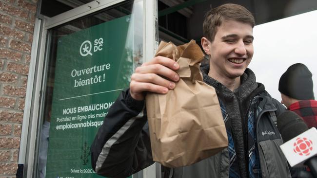 A young man holds a bag of marijuana bought in a shop in Quebec City, Canada. Picture: AFP