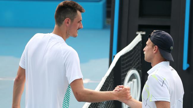 Bernard Tomic congratulates Denis Kudla after an Australian Open qualifying match in Melbourne last year. Both men were winners in Doha on Monday, but the American has tested positive to coronavirus Picture: Michael Klein