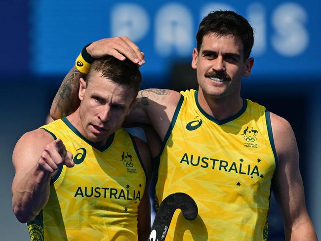 Australia's forward #05 Tom Wickham (L) celebrates scoring his team's in the men's pool B field hockey match between New Zealand and Australia during the Paris 2024 Olympic Games at the Yves-du-Manoir Stadium in Colombes on August 1, 2024. (Photo by Miguel MEDINA / AFP)