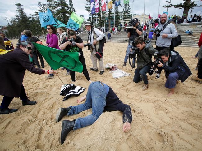 XR Spring Rebellion: Heads in the Sand event at Manly Beach today (11/10/2019). Matt Parmeter of Dubbo, buries his head in the sand at the event. Pic Liam Driver