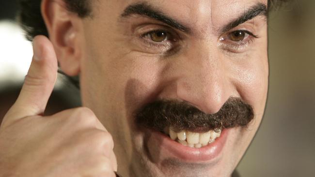 Actor Sacha Baron Cohen arrives in character as Borat Sagdiyev for the film premiere of 'Borat: Cultural Learnings of America for Make Benefit Glorious Nation of Kazakhstan" in Los Angeles, Oct. 23, 2006. - headshot smiling thumbs /up