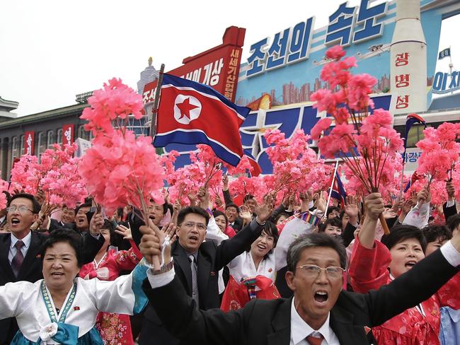 Parade participants march with a model of the Unha space launch vehicle at the Kim Il Sung Square.  Picture:  AP