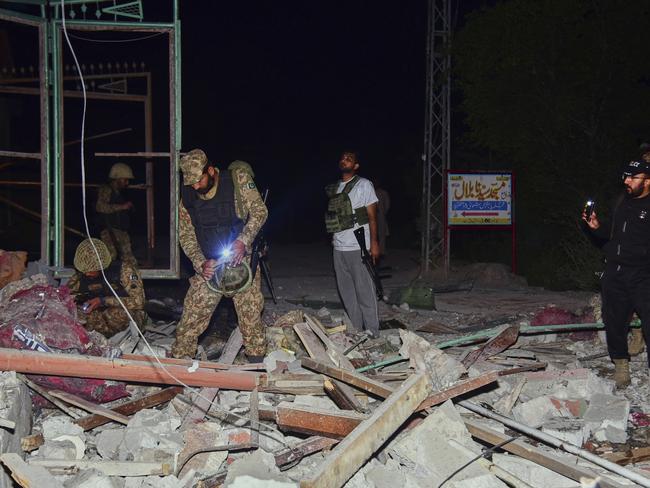 Army soldiers examine a building damaged by a suspected Indian missile attack near Muzaffarabad, the capital of Pakistan controlled Kashmir. Picture: AP