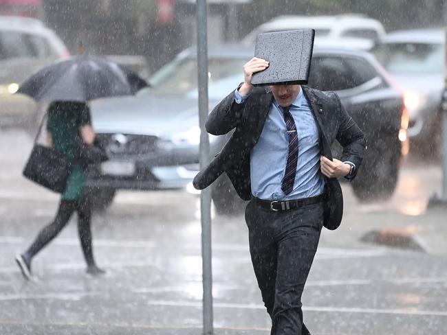 BRISBANE, AUSTRALIA - NewsWire Photos - FEBRUARY 2, 2021.People make their way through heavy rain in central Brisbane. A severe thunderstorm warning with possible flash flooding has been issued for the southeast, including Brisbane CBD, as wet weather causes traffic chaos on Tuesday morning.Picture: NCA NewsWire / Dan Peled