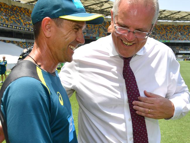 Australian cricket team coach Justin Langer (left) is seen with Australian Prime Minister Scott Morrison (right) during the Australian Men's cricket team training session at the Gabba in Brisbane, Wednesday, November 20, 2019. Australia will take on Pakistan in the first test at the Gabba from Thursday.  (AAP Image/Darren England) NO ARCHIVING