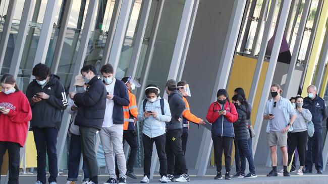 People line up to get their COVID vaccinations at the Melbourne Exhibition Centre. Picture: NCA NewsWire / David Crosling